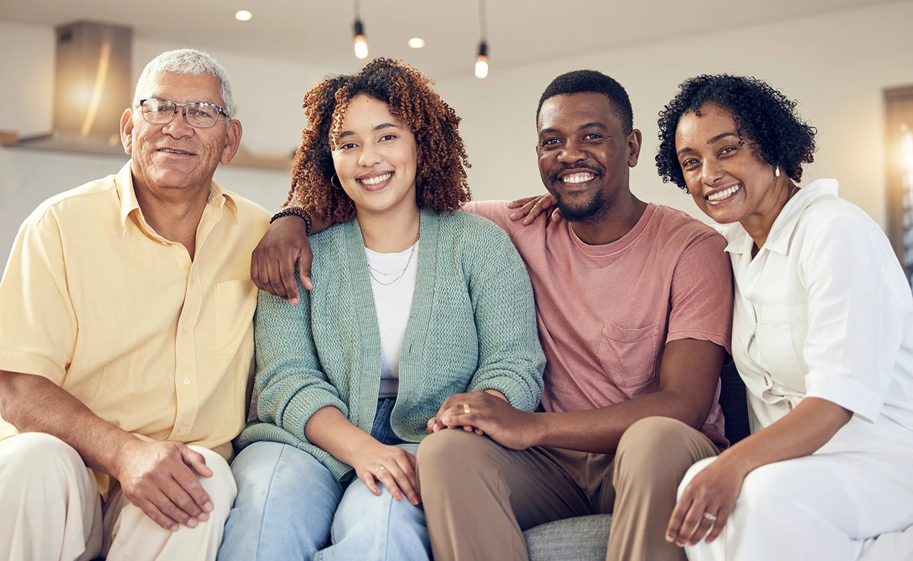 Happy multigenerational family smiling together on couch