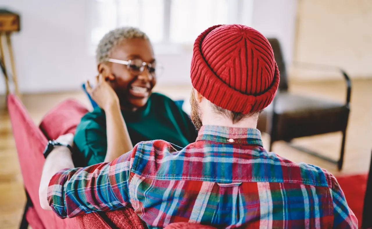 Two people having a friendly conversation indoors